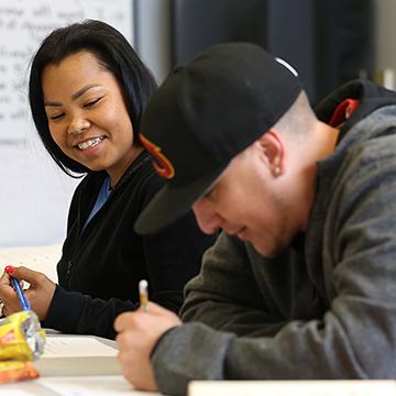 Two students enjoy a JCAE class that is helping them prepare to take the GED®.